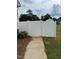Gated entrance to backyard with level concrete walk and low maintenance vinyl privacy fencing for safety at 3901 La Varra Dr, Clayton, NC 27520