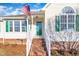 Front entry with brick steps and green door at 3901 La Varra Dr, Clayton, NC 27520