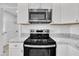 Modern kitchen features stainless steel appliances and granite countertops at 3901 La Varra Dr, Clayton, NC 27520