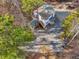 Aerial view of the home with a large parking area, outbuilding, fire pit, and a wooded landscape at 497 Turn Key Way, Pittsboro, NC 27312