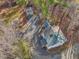 Aerial view of the home with a large parking area and a wooded landscape with surrounding foliage at 497 Turn Key Way, Pittsboro, NC 27312