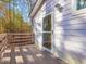 A charming deck and door to the home's exterior that has natural light and wooden railings at 497 Turn Key Way, Pittsboro, NC 27312