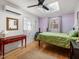 Bright bedroom with a skylight, wood floors, and a red console table at 497 Turn Key Way, Pittsboro, NC 27312