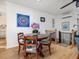 Charming dining area with a round wooden table and unique artwork on the wall at 497 Turn Key Way, Pittsboro, NC 27312
