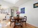 Charming dining area with a round wooden table, skylight, and modern decor at 497 Turn Key Way, Pittsboro, NC 27312