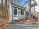 Exterior of a charming outbuilding near the main house with a decorative screen door, surrounded by mature trees at 497 Turn Key Way, Pittsboro, NC 27312