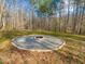 Outdoor fire pit featuring a gravel surround and brick edging, perfect for cozy gatherings at 497 Turn Key Way, Pittsboro, NC 27312