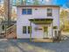 Charming home exterior featuring a covered porch, beautiful landscaping, and multiple windows for abundant natural light at 497 Turn Key Way, Pittsboro, NC 27312