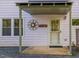 A home entrance that has a welcoming sign and plenty of natural light provided by several windows at 497 Turn Key Way, Pittsboro, NC 27312