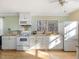 Bright kitchen with white cabinets, butcher block countertops, and stainless-steel appliances at 497 Turn Key Way, Pittsboro, NC 27312