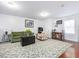 Inviting living area with comfortable seating, floral rug, and a unique trunk coffee table, bathed in natural light at 497 Turn Key Way, Pittsboro, NC 27312