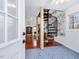 The open-concept living space has a spiral staircase and gleaming hardwood floors leading to a well-lit office space at 497 Turn Key Way, Pittsboro, NC 27312