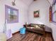 Small room with a vaulted ceiling, two windows, a love seat, and hardwood floors at 497 Turn Key Way, Pittsboro, NC 27312