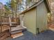 A cozy shed features a small deck and well-maintained wood siding, creating an inviting outdoor space at 497 Turn Key Way, Pittsboro, NC 27312