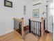 Open staircase with hardwood steps, black metal railing, and white trim at 497 Turn Key Way, Pittsboro, NC 27312