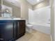 Bathroom with tub and dark brown vanity at 5023 Lalex Ln, Cary, NC 27519