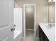 Clean bathroom with double vanity, bathtub, and additional toilet room at 5023 Lalex Ln, Cary, NC 27519