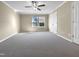Spacious bedroom with carpeted floor, ceiling fan, and ample closet space at 5023 Lalex Ln, Cary, NC 27519