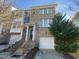 Brick front exterior of charming townhome with attached garage at 5023 Lalex Ln, Cary, NC 27519