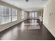 Sunlit living room featuring hardwood floors and a lofted ceiling at 5023 Lalex Ln, Cary, NC 27519