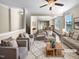 Virtually staged living room featuring neutral colored couches and a coffee table at 5023 Lalex Ln, Cary, NC 27519