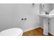 Powder room with pedestal sink and hardwood floor at 520 Matheson Pl, Cary, NC 27511