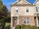 Two-story brick home with a charming front porch and well-manicured landscaping at 520 Matheson Pl, Cary, NC 27511