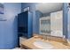 Bathroom with granite countertop and blue vanity at 6539 English Oaks Dr, Raleigh, NC 27615