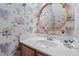 Small bathroom with vanity and bird-themed wallpaper at 6539 English Oaks Dr, Raleigh, NC 27615