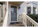 Front door entry with a gray door and nautical doormat at 6539 English Oaks Dr, Raleigh, NC 27615