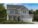 Two-story home with gray siding, white trim, and a covered porch at 661 Morning Glade St, Wake Forest, NC 27587