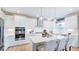 Modern kitchen with white cabinets, stainless steel appliances, and an island at 661 Morning Glade St, Wake Forest, NC 27587