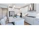 Modern kitchen with white cabinets, stainless steel appliances, and an island at 661 Morning Glade St, Wake Forest, NC 27587