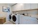 Convenient laundry room with washer, dryer, and cabinets at 661 Morning Glade St, Wake Forest, NC 27587
