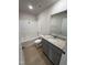 Clean bathroom with grey vanity, granite countertop, and a bathtub at 75 Shiloh Dr, Lillington, NC 27546