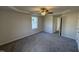 Spacious bedroom featuring grey carpet and ceiling fan at 75 Shiloh Dr, Lillington, NC 27546