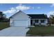 Newly constructed home with a white exterior, gray roof, and a two-car garage at 75 Shiloh Dr, Lillington, NC 27546