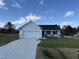 Newly constructed home with a white exterior, gray roof, and a two-car garage at 75 Shiloh Dr, Lillington, NC 27546