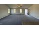 Bright living room with grey carpet, neutral walls, and multiple windows at 75 Shiloh Dr, Lillington, NC 27546