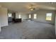 Open living room with hardwood and carpet flooring, and a view into the kitchen at 75 Shiloh Dr, Lillington, NC 27546