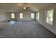 Spacious living room with grey carpet, neutral walls, and multiple windows at 75 Shiloh Dr, Lillington, NC 27546