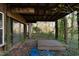 Home's exterior with overgrown landscaping and a shed at 90 Little Indian Creek Rd, Goldston, NC 27252