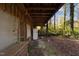 Home's exterior with covered porch and wooded surroundings at 90 Little Indian Creek Rd, Goldston, NC 27252