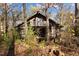 Rustic log cabin nestled in woods, features balcony and large windows at 90 Little Indian Creek Rd, Goldston, NC 27252