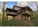 Two-story home with wood siding and a large deck at 90 Little Indian Creek Rd, Goldston, NC 27252