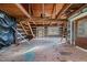Open concept interior with exposed beams and unfinished flooring at 90 Little Indian Creek Rd, Goldston, NC 27252