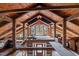 Unfinished loft area with exposed beams and wood flooring at 90 Little Indian Creek Rd, Goldston, NC 27252