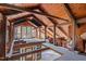 Unfinished loft area with exposed beams and wood flooring at 90 Little Indian Creek Rd, Goldston, NC 27252