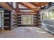 Unfinished interior room with exposed beams and wood walls at 90 Little Indian Creek Rd, Goldston, NC 27252