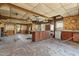 Large kitchen with island and wood cabinets, needing renovation at 90 Little Indian Creek Rd, Goldston, NC 27252